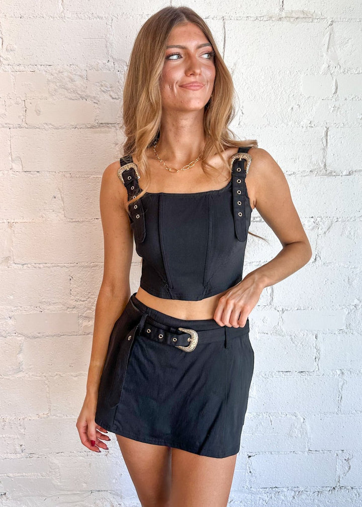 Statement buckle detailing for a modern, edgy look
Fitted silhouette for a sleek, flattering fit
Versatile black color for easy styling
Perfect for casual outings or nights out