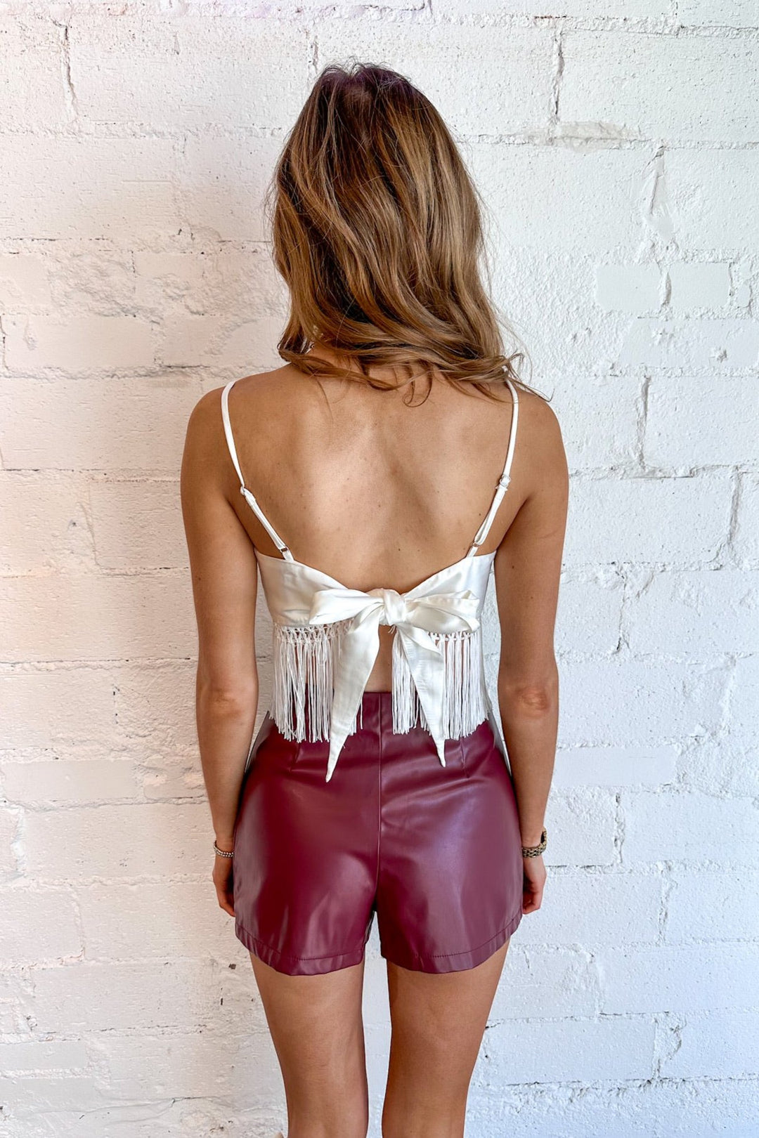 Available in rich sienna and crisp white
Fringe detailing for a boho-inspired touch
Tie-back design for a playful, open-back look
Lightweight fabric for year-round versatility