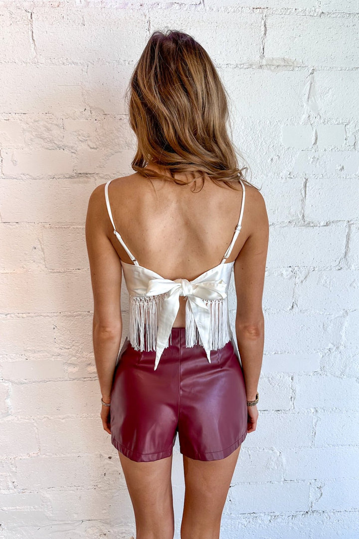 Available in rich sienna and crisp white
Fringe detailing for a boho-inspired touch
Tie-back design for a playful, open-back look
Lightweight fabric for year-round versatility