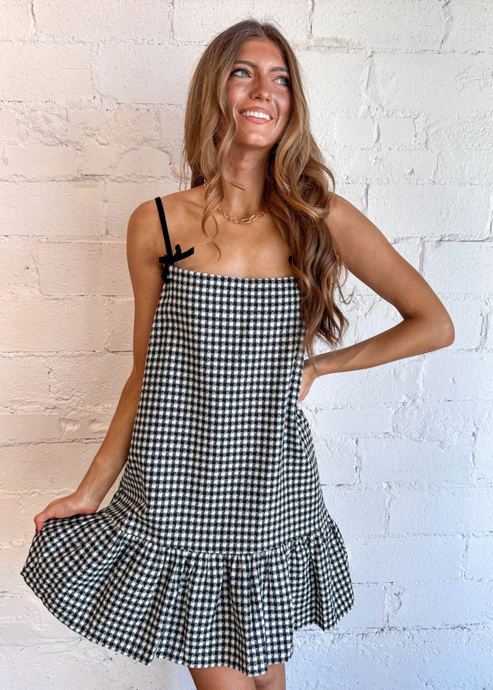 Classic plaid pattern for a timeless appeal
Adjustable ribbon straps for a personalized fit
Ruffle hem detail adds a playful touch
Lightweight fabric for comfort and breathability